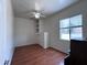 Bright bedroom with built-in shelving, ample natural light, and wood flooring at 2427 W Desert Hills Estate Dr, Phoenix, AZ 85086