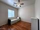 Bedroom showcasing wood floors, a window, ceiling fan, and a cozy space at 2427 W Desert Hills Estate Dr, Phoenix, AZ 85086