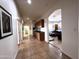 Long hallway featuring tile floors, archway leading to living area, and built-in cabinets at 2427 W Desert Hills Estate Dr, Phoenix, AZ 85086