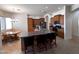 Open kitchen features granite countertops, island with bar seating, and stainless appliances at 2427 W Desert Hills Estate Dr, Phoenix, AZ 85086