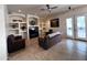 Open concept living room featuring built-in shelving and a ceiling fan at 2427 W Desert Hills Estate Dr, Phoenix, AZ 85086