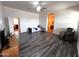 Bright living room featuring wood-style floors, ceiling fan, and easy bathroom access at 2427 W Desert Hills Estate Dr, Phoenix, AZ 85086