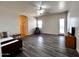 Spacious living room with wood-style floors, ceiling fan, and access to the outdoors at 2427 W Desert Hills Estate Dr, Phoenix, AZ 85086