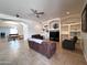Open living room with tile flooring, ceiling fan and built-in shelving at 2427 W Desert Hills Estate Dr, Phoenix, AZ 85086