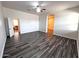 Spacious main bedroom featuring dark wood flooring and an open doorway to another room at 2427 W Desert Hills Estate Dr, Phoenix, AZ 85086