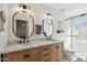 Bathroom featuring a dual sink vanity with a stone countertop and walk-in shower at 2435 E Jensen St, Mesa, AZ 85213