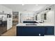 Modern kitchen with white cabinets, stainless steel appliances, and a central island with blue cabinets at 2435 E Jensen St, Mesa, AZ 85213
