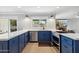 Modern kitchen with blue cabinets, stainless steel appliances, white countertops, and recessed lighting at 2435 E Jensen St, Mesa, AZ 85213