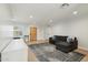 Bright living room featuring hardwood floors, fresh paint, and a rustic wooden front door at 2435 E Jensen St, Mesa, AZ 85213