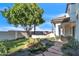 Expansive backyard featuring mature tree, stone patio and grass with decorative pond at 2662 N Chestnut Cir, Mesa, AZ 85213