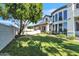 Mature backyard featuring large trees, green grass and landscaped flower beds surrounding the home at 2662 N Chestnut Cir, Mesa, AZ 85213