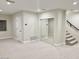 Finished basement featuring neutral walls and carpet with staircase and mirrored closet at 2662 N Chestnut Cir, Mesa, AZ 85213