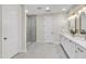 Upscale bathroom with marble floors, a glass enclosed shower and a double sink vanity with modern fixtures at 2662 N Chestnut Cir, Mesa, AZ 85213