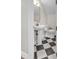 Charming bathroom with pedestal sink, gold faucet, tiled floors, and classic fixtures at 2662 N Chestnut Cir, Mesa, AZ 85213