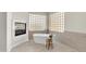 Modern bathroom features a freestanding tub with glass block window for natural light and privacy at 2662 N Chestnut Cir, Mesa, AZ 85213