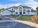 Beautiful two-story white home with a manicured lawn and a brick driveway in a desirable neighborhood at 2662 N Chestnut Cir, Mesa, AZ 85213