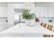 Bright kitchen featuring a marble countertop island, white cabinetry, stainless steel appliances, and modern lighting at 2662 N Chestnut Cir, Mesa, AZ 85213