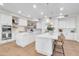 Modern kitchen with two islands, white cabinets, stainless steel appliances, and sleek lighting at 2662 N Chestnut Cir, Mesa, AZ 85213