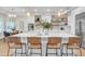 Stylish kitchen boasts large island with seating, stainless appliances, pendant lights, and wood floors at 2662 N Chestnut Cir, Mesa, AZ 85213