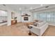 Bright living room with a whitewashed brick fireplace, neutral furniture, and lots of natural light at 2662 N Chestnut Cir, Mesa, AZ 85213