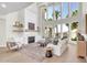 Bright, open living room featuring a fireplace, high ceilings, and a wall of windows at 2662 N Chestnut Cir, Mesa, AZ 85213