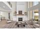 Spacious living room featuring a marble fireplace, high ceilings, and comfortable seating area at 2662 N Chestnut Cir, Mesa, AZ 85213