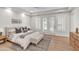 Bright and airy main bedroom with hardwood floors, shutters, and a cozy seating area at 2662 N Chestnut Cir, Mesa, AZ 85213