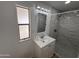 This bathroom offers updated shower, vanity, mirror, lighting and is brightly lit with a window at 303 S Recker Rd # 50, Mesa, AZ 85206