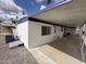 Exterior view of a mobile home featuring an attached carport, windows, and siding at 303 S Recker Rd # 50, Mesa, AZ 85206