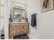 Bathroom featuring wood vanity with white marble top and framed mirror at 3047 W Sandra Ter, Phoenix, AZ 85053