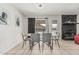 Bright dining area with tiled floors, black stone fireplace, and a view of the outdoor pool at 3047 W Sandra Ter, Phoenix, AZ 85053