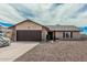 A single-level home with stone accents on the garage, desert landscaping, and a welcoming entrance at 3047 W Sandra Ter, Phoenix, AZ 85053