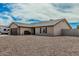 Charming single-story home featuring a stone-accented garage, neutral stucco, and low-maintenance desert landscaping at 3047 W Sandra Ter, Phoenix, AZ 85053