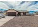 Inviting single-Gathering home showcasing a well-manicured yard, stone accents, and an attached two-car garage at 3047 W Sandra Ter, Phoenix, AZ 85053