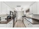 Bright kitchen with white cabinets, dark countertops and stainless steel appliances at 3047 W Sandra Ter, Phoenix, AZ 85053