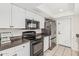 This kitchen features white cabinets, stainless steel appliances, and dark countertops at 3047 W Sandra Ter, Phoenix, AZ 85053
