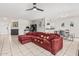 Open-concept living room with tile floors, a cozy sectional sofa, and a view into the kitchen at 3047 W Sandra Ter, Phoenix, AZ 85053