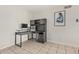 Office space featuring a sleek desk, a modern computer setup, and tile flooring at 3047 W Sandra Ter, Phoenix, AZ 85053
