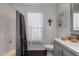 Bathroom view featuring shower/tub, vanity, natural light, and neutral tones at 30517 W Lynwood St, Buckeye, AZ 85396