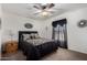 This primary bedroom features a beautiful ceiling fan and a classic bed at 30517 W Lynwood St, Buckeye, AZ 85396