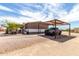 Charming exterior view showcasing a covered parking area and a well-maintained gravel driveway at 30517 W Lynwood St, Buckeye, AZ 85396