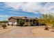 Well-maintained single-story home with a charming front porch and low-maintenance landscaping at 30517 W Lynwood St, Buckeye, AZ 85396