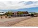 Inviting single-story home featuring desert landscaping, a gravel driveway, and a covered carport at 30517 W Lynwood St, Buckeye, AZ 85396