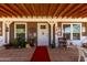 Charming front porch with inviting decor, mature plants, and ample space for seating at 30517 W Lynwood St, Buckeye, AZ 85396