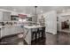Bright kitchen features a center island, gray cabinetry, tile backsplash, and stylish decor at 30517 W Lynwood St, Buckeye, AZ 85396
