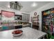 Bright kitchen with center island, gray cabinetry, pantry, and decorative shelving at 30517 W Lynwood St, Buckeye, AZ 85396