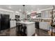Open kitchen with a center island, gray cabinets, recessed lighting, and modern appliances at 30517 W Lynwood St, Buckeye, AZ 85396