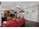 Comfortable living room with wood entertainment center and a bright red sofa at 30517 W Lynwood St, Buckeye, AZ 85396