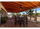 Inviting covered porch featuring a dining area and views of the landscaped exterior at 30517 W Lynwood St, Buckeye, AZ 85396