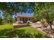 Picturesque backyard featuring a covered patio, outdoor dining area, and beautifully landscaped greenery at 3239 S Tatum Ln, Gilbert, AZ 85297